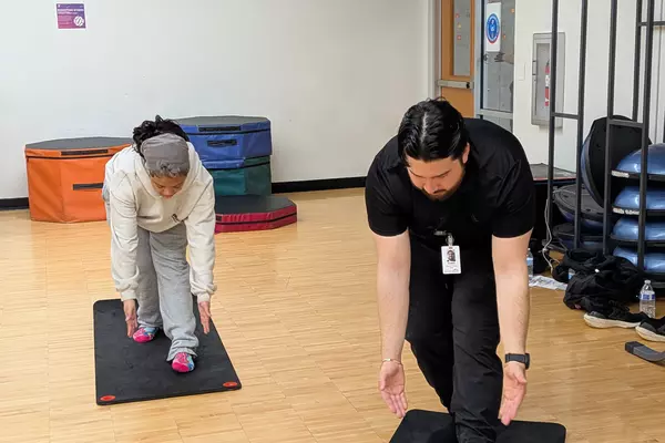 A Puget Sound student instructs a high school student on proper form. 