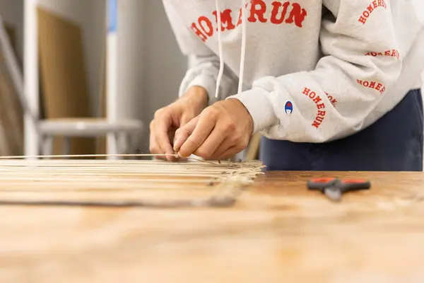 Hands weaving 