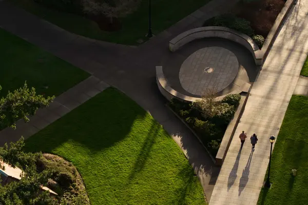 Students walk by Benefactor Plaza as seen from above