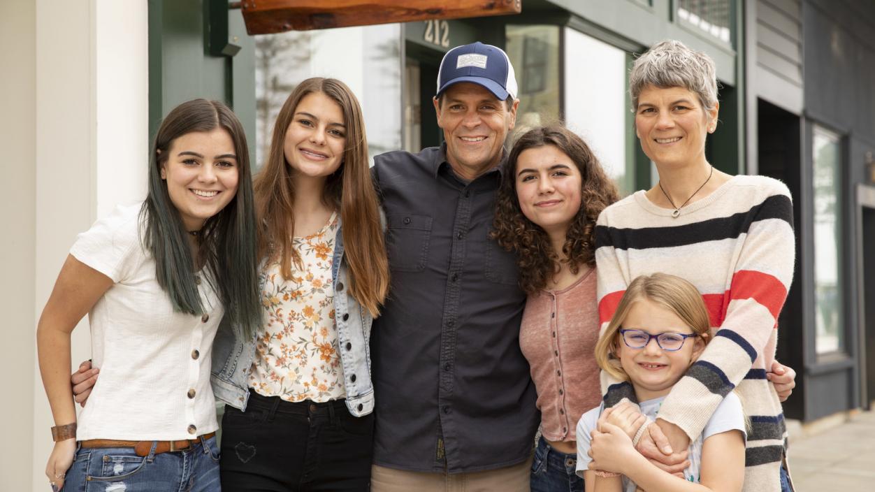 Casey Roloff standing with his wife and their four daughters