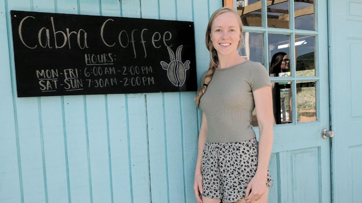 Woman standing in front of a coffee shop