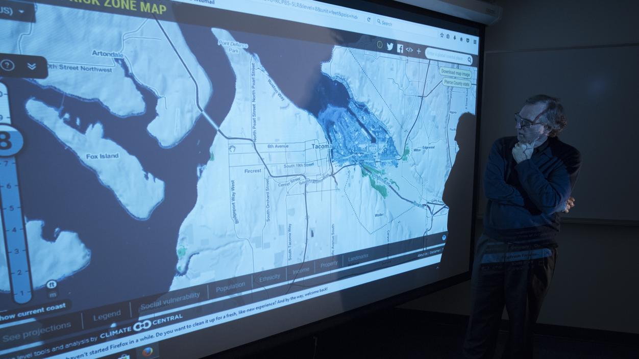 A person looking at a map of Tacoma projected on a large screen