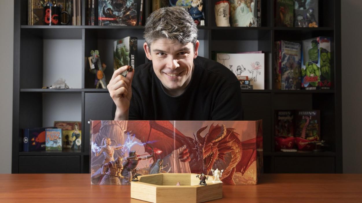 Adam Davis '06 poses with Dungeons and Dragons supplies