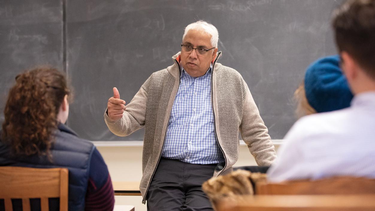 Professor Sunil Kukreja talking to students in a classroom