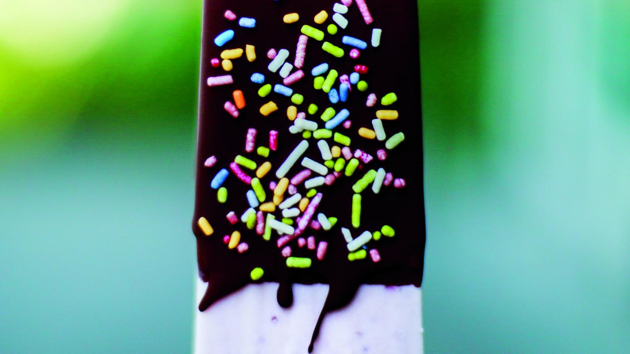 Frozen chocolate covered pop with sprinkles