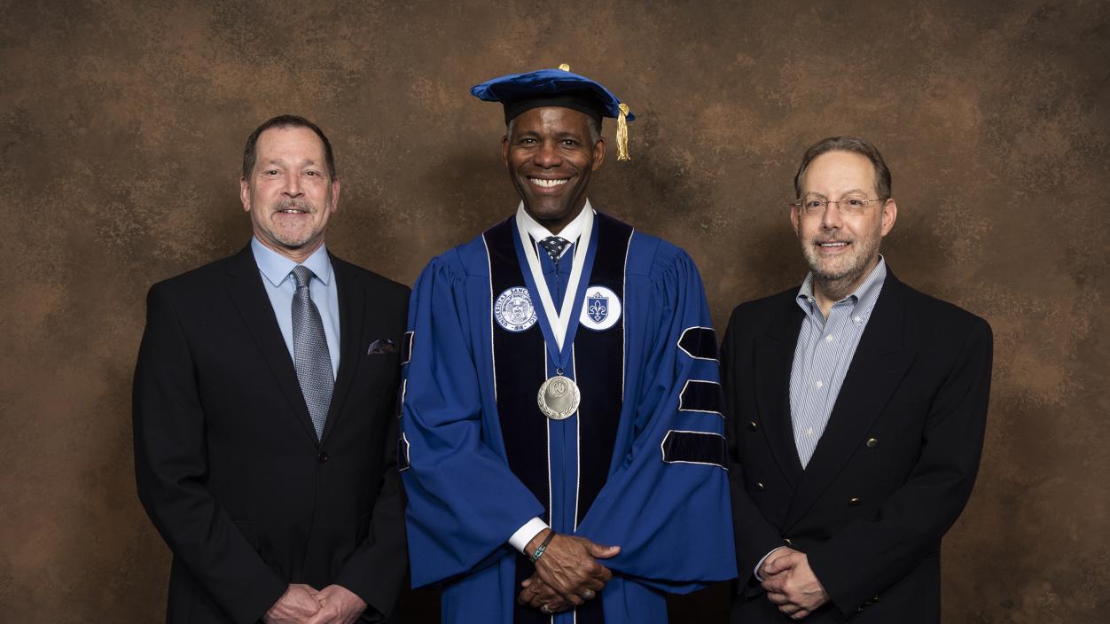 President Isiaah Crawford (center) with Kent Korneisel (left) and Robert Palermo, president of The Rosa Corporation (left)