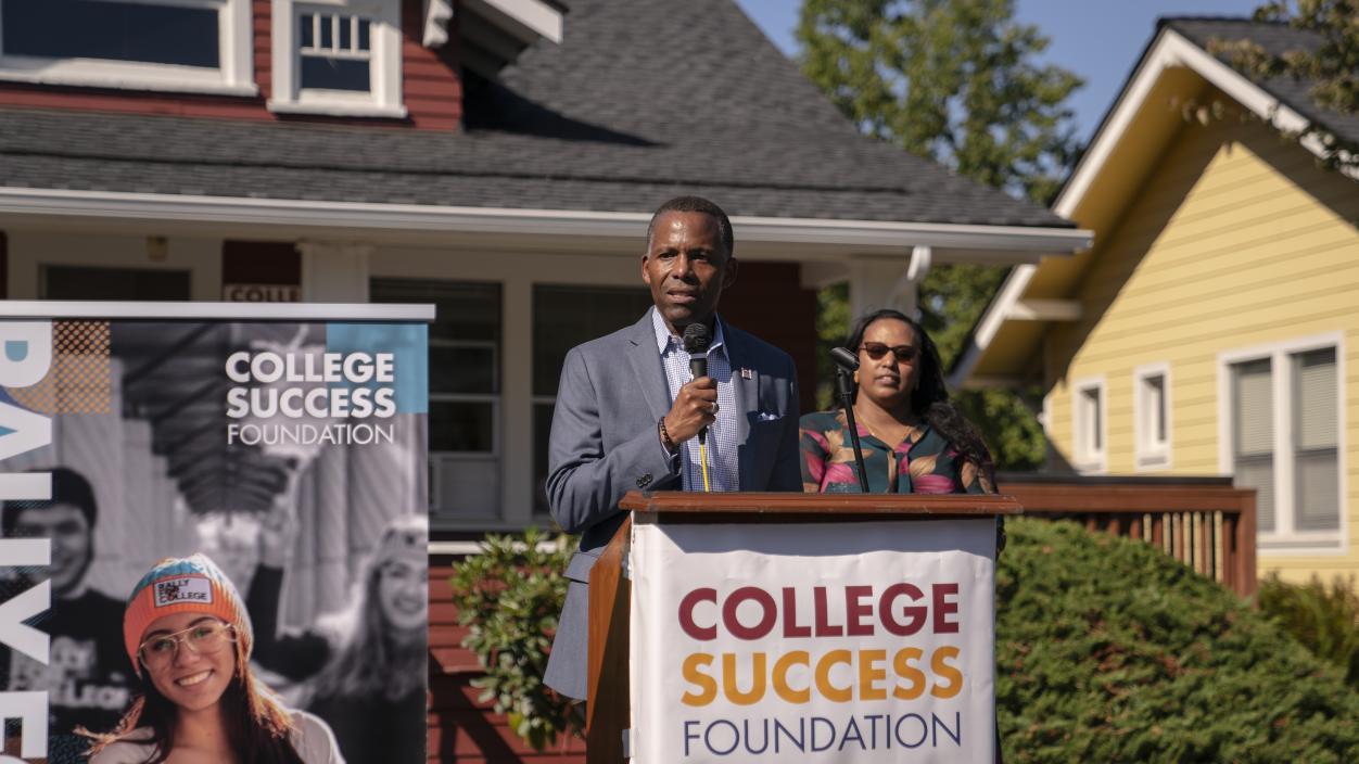 President Isiaah Crawford at the podium during the College Success Foundation open house