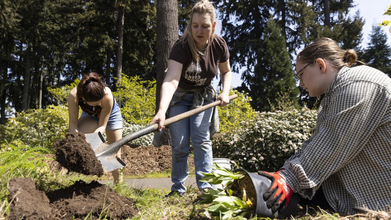Lexi Brewer and students tend to plantings on campus