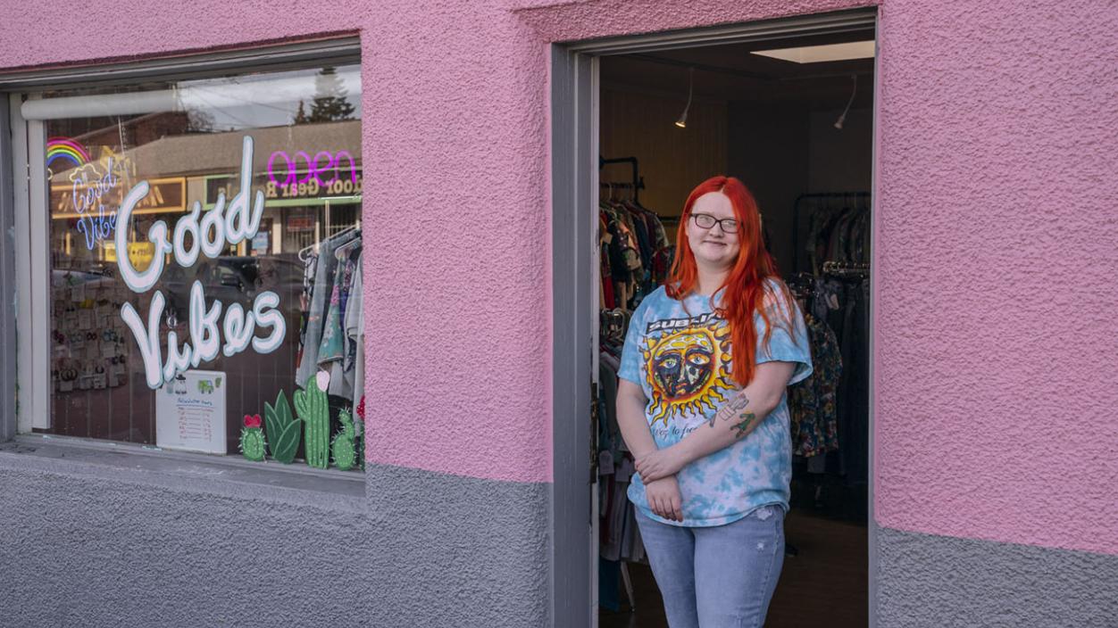 Madyson Willoughby ’19 stands outside of her second-hand clothing shop in Tacoma's Sixth Avenue District.