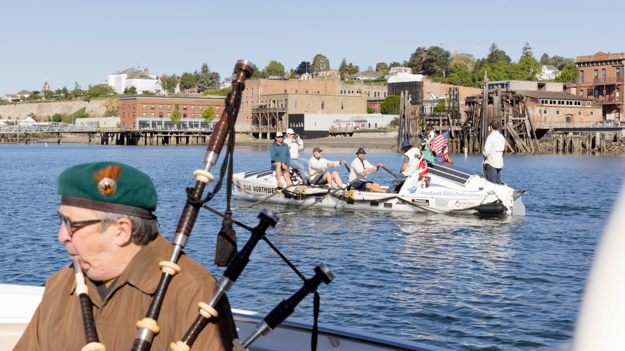 In June 2023, bagpipers played as the James Robert Hanssen rowed its last mile to the Port Townsend boatyard, where volunteers dismantled it. Photo by Alex Crook.