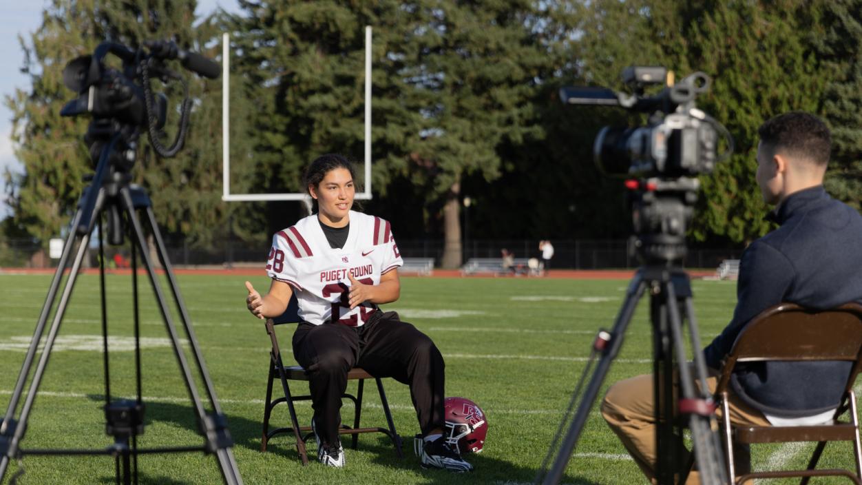 Liluy Godwin ’26 being interviewed by KING 5 about her history making tackle.