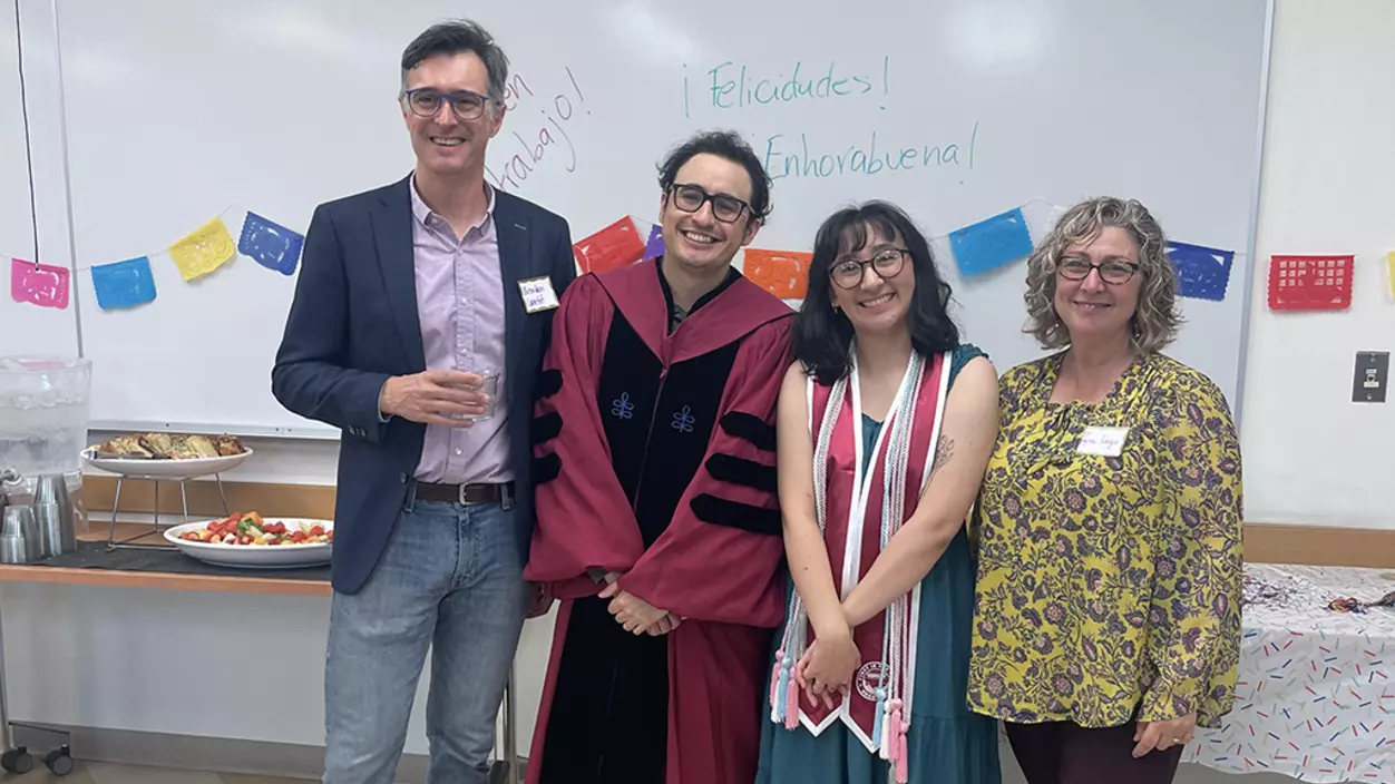 Angela Ronces-Cortes ’24 celebrates her graduation with faculty members Brendan Lanctot (left), Jairo Hoyos Galvis (second from left), and Pepa Lago-Grana (right).