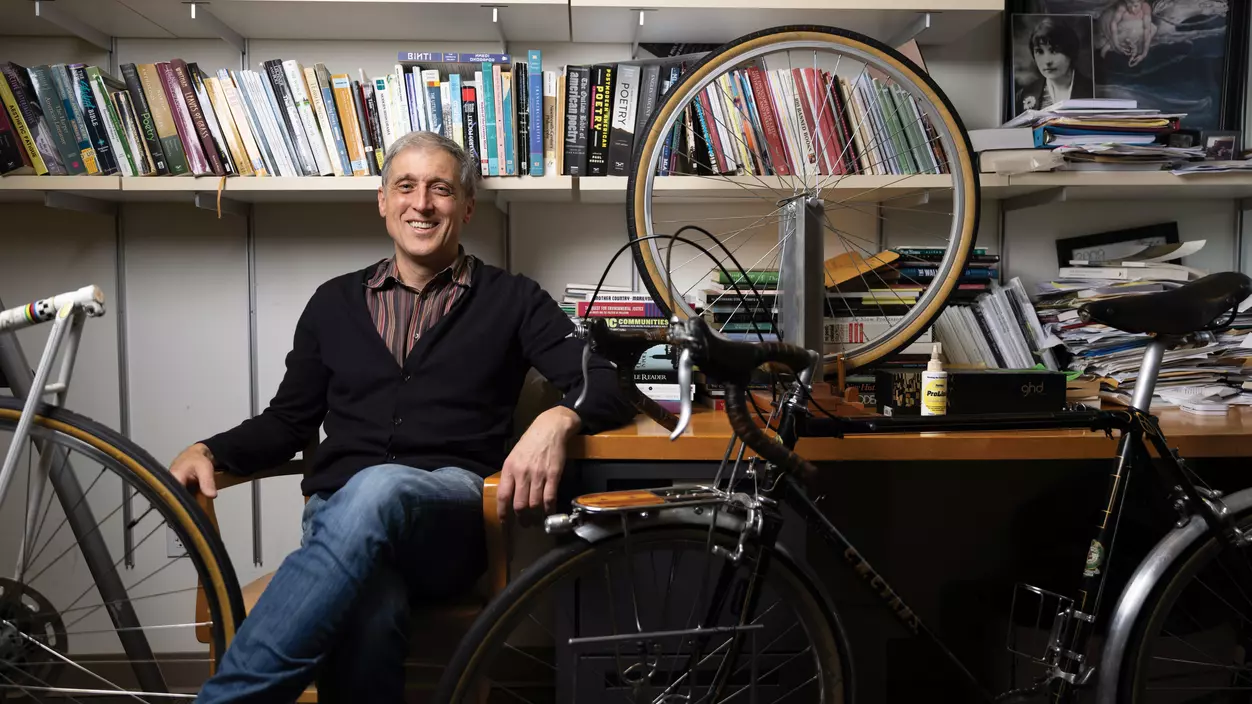 Prof. Bill Kupinse with his bike in his office on campus.