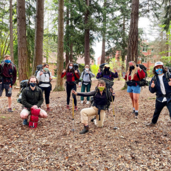 Students backpack training in the woods on campus
