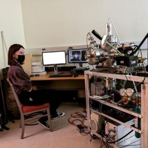 Student sits at desk with reactor