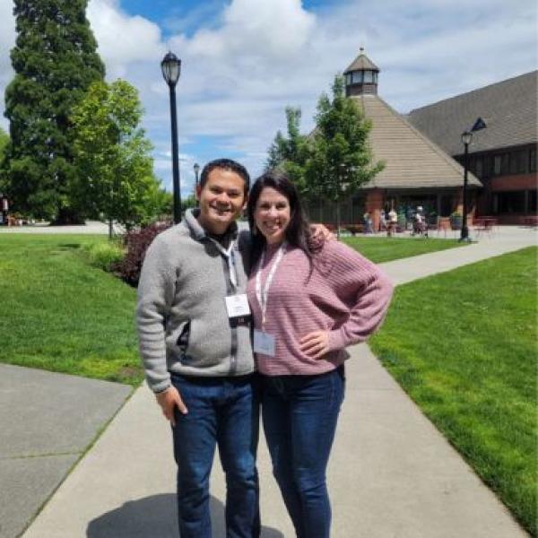 Two people pose for photo on campus