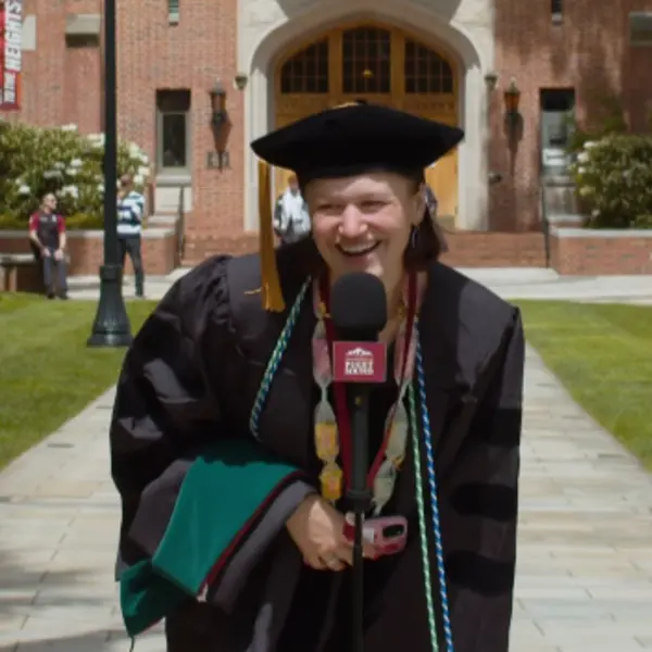 A grad gives a shout out on graduation day.