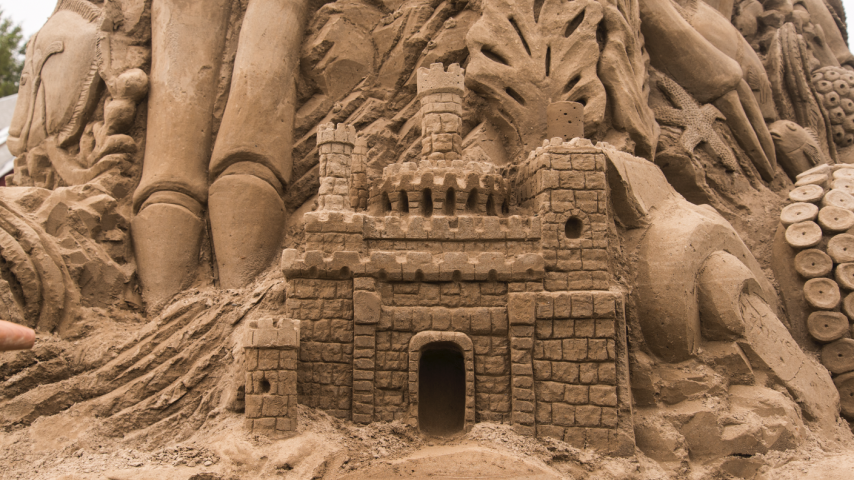 Detailed view of the sand sculpture, showing a sand castle