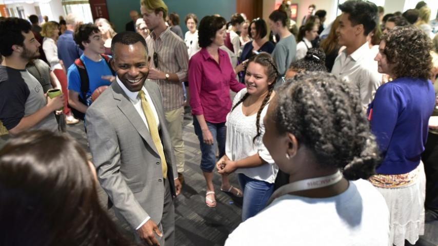 Students, faculty, and staff greet President Crawford at a coffee reception outside Diversions Cafe