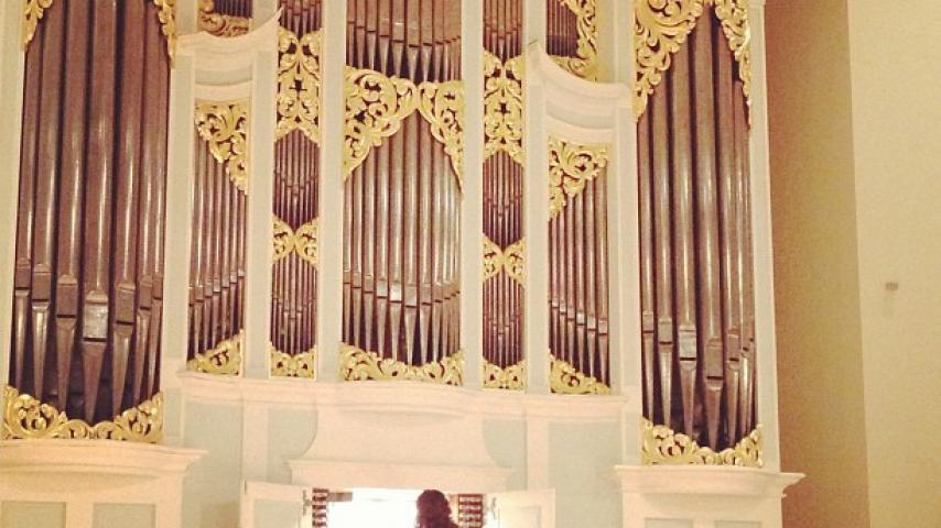 A person playing a pipe organ
