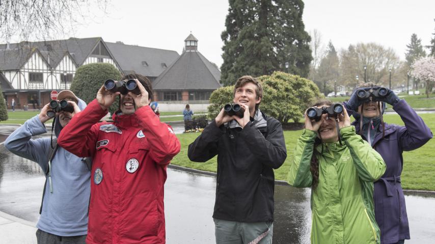 A group of people using binoculars