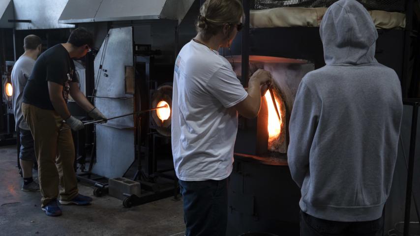 People using glass blowing furnaces
