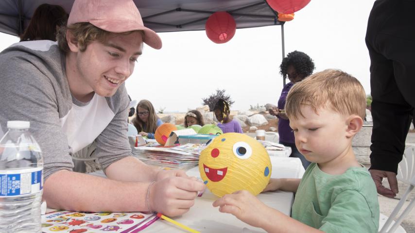 A person creating decorations with children