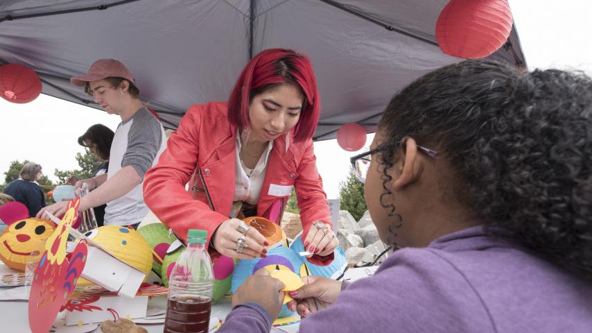 A person creating decorations with children