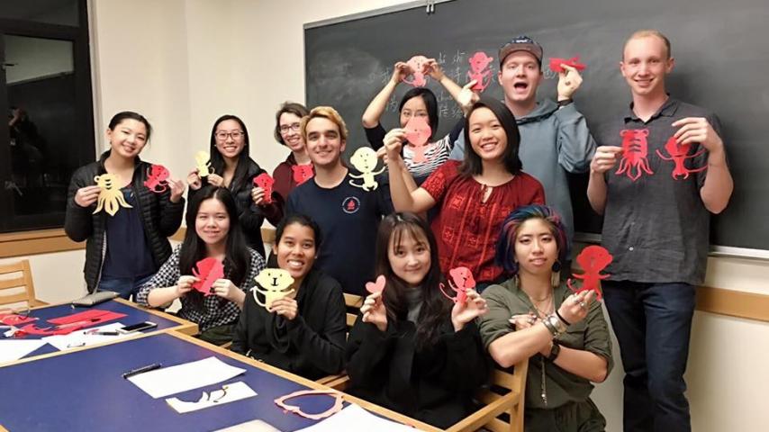 Students holding paper animal cut-outs