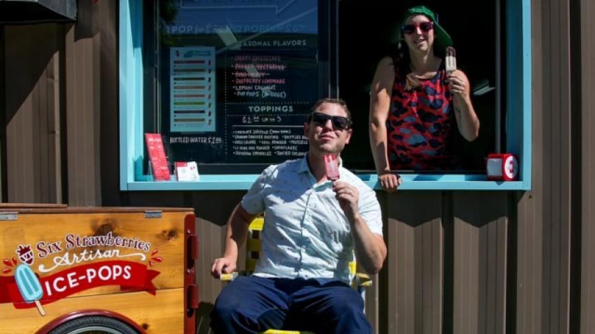Two people at an ice-pop stand