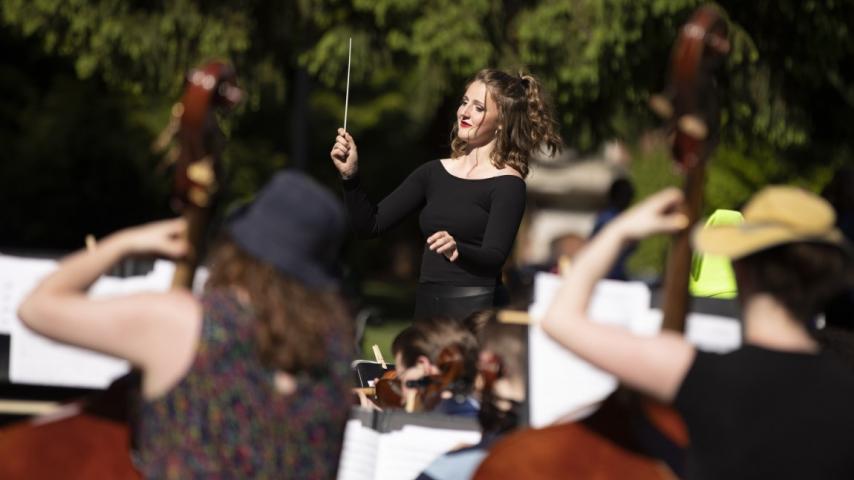Woman conducting a group of musicians