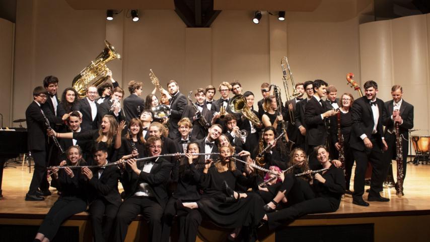 Large group of musicians posing with instruments