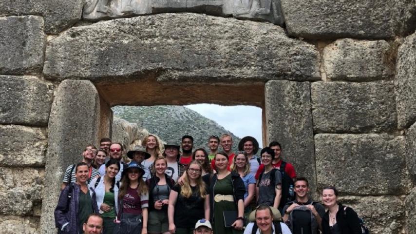 Students posing in front of Greek ruins