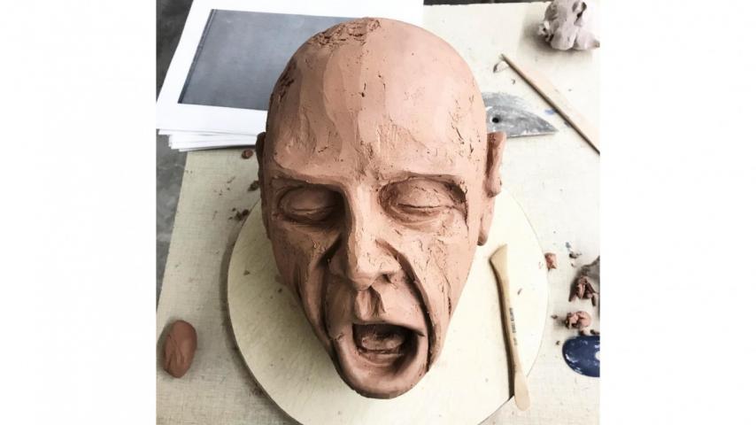 clay sculpture of a face 