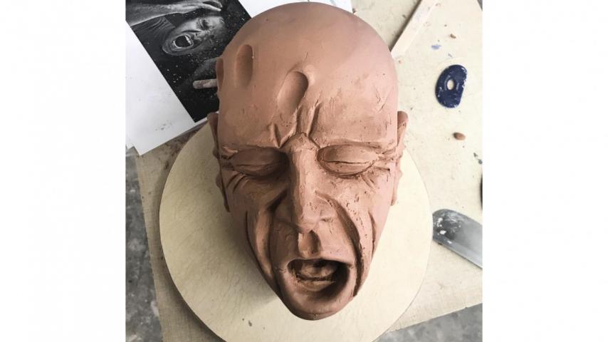 clay sculpture of a face in progress