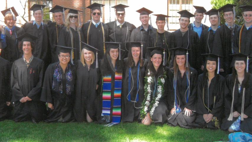 1012 Math and CS grads in regalia standing on a lawn.