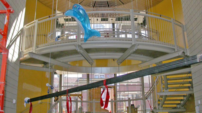 The atrium of Harned Hall. There was a whale already in place but it was the wrong color. The beam is hanging from the ceiling mounts 39 feet above the floor and will serve as the temporary hanger for whale assembly and for lifting the whale into place prior to permanent cabling.