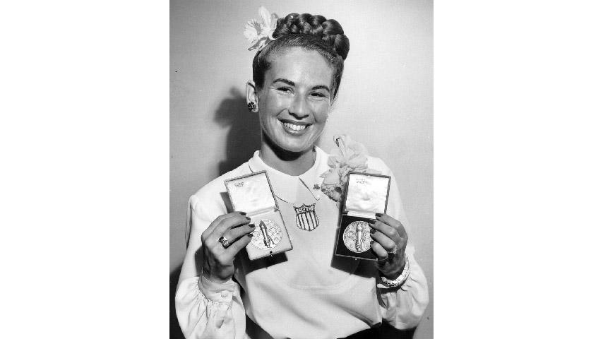 Gretchen Kunigk Fraser ’41 showing off her two Olympic medals from St. Moritz: a gold in slalom and a silver in alpine combined