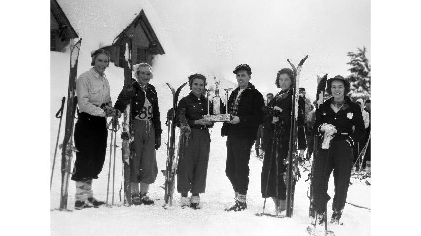 This 1938 photo appears to show at least part of the College of Puget Sound Ski Club outside Paradise Lodge at Mt. Rainier after a race. Gretchen Kunigk ’41 is second from left.