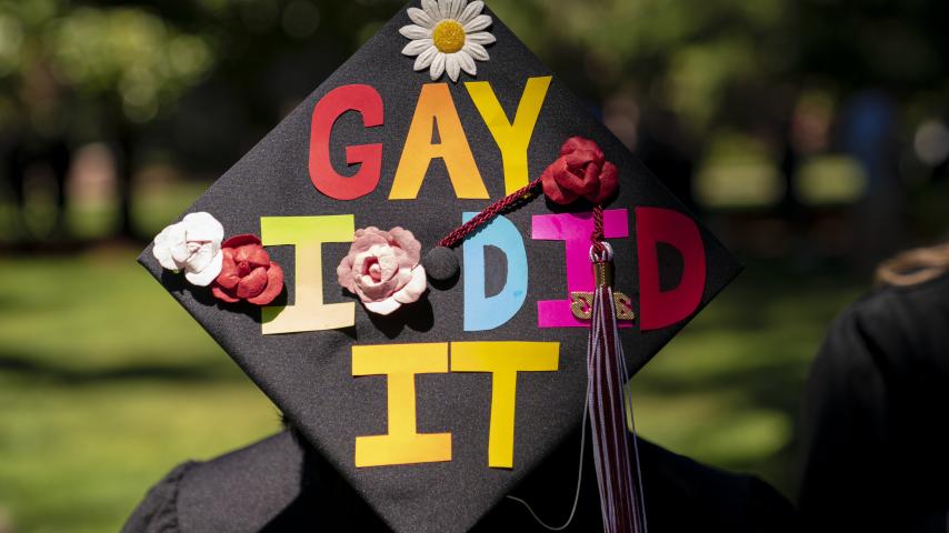 Many students decorate their mortar board caps with personalized messages.
