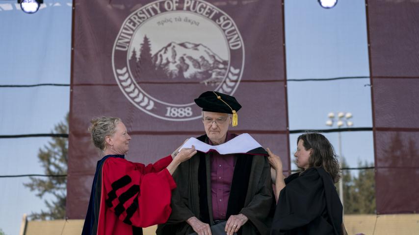 Commencement speaker and honorand Bill Baarsma '64, P'93 receives his honorary degree.