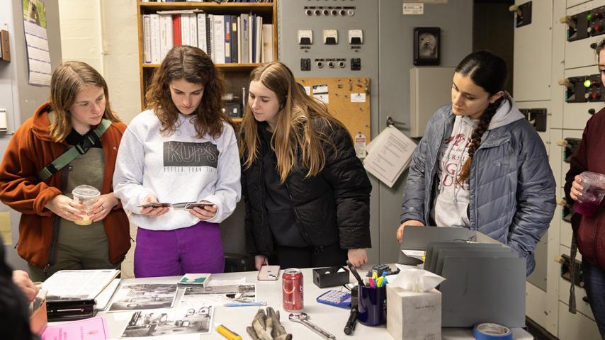 Students looking at prison archives ephemera