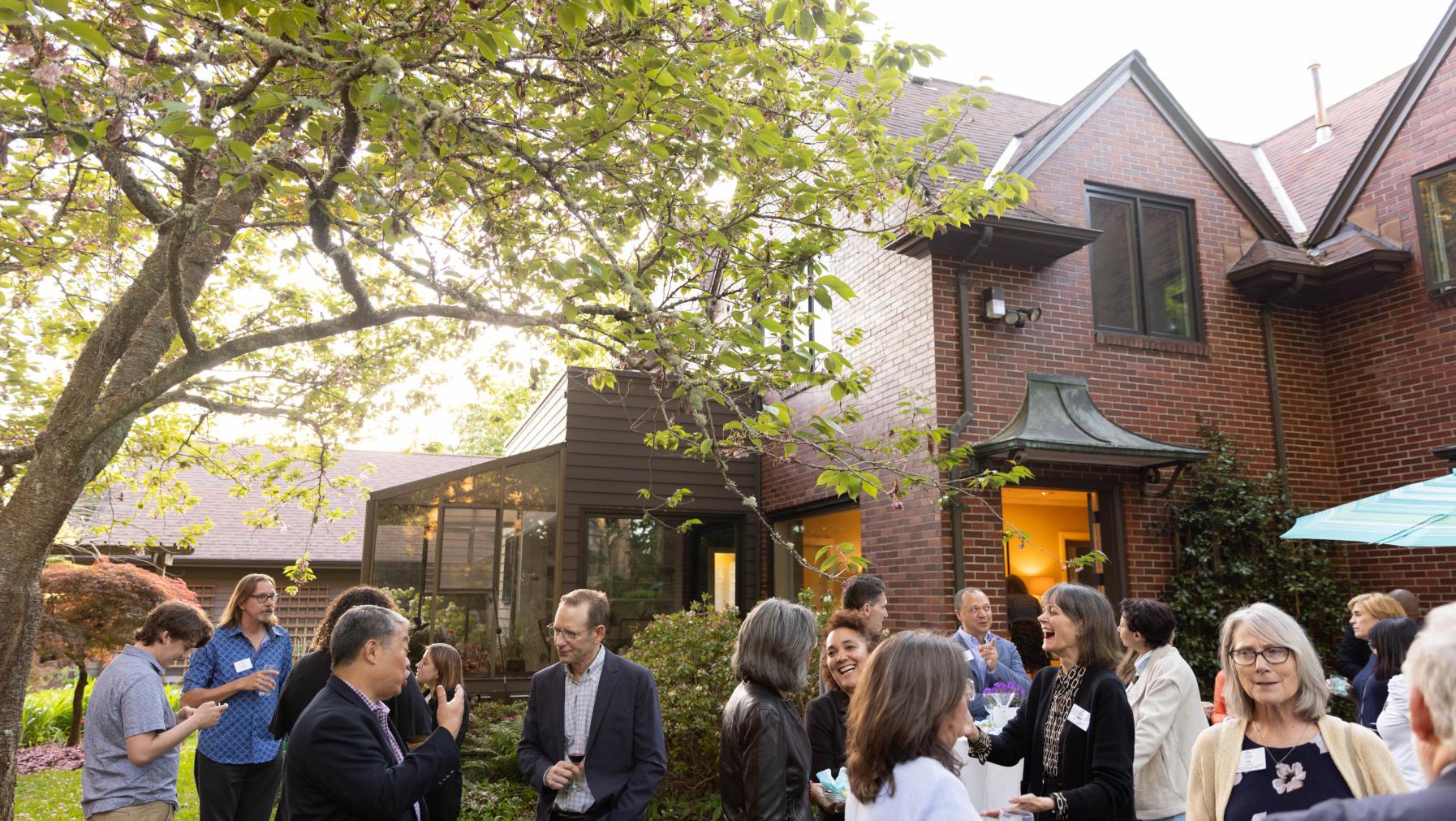Trustees and guests share fellowship at the president's residence.