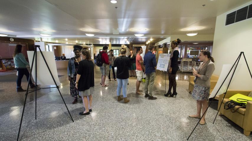 Poster presenters at the 2014 RPNC in the lobby of the Wheelock Student Center.