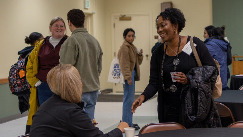 Renee Simms reconnecting with a community partner at a post-presentation by Nolan Cabrera where his talk was titled, Whiteness: A Primer on the Core Barrier to Racial Liberation in November 2022.