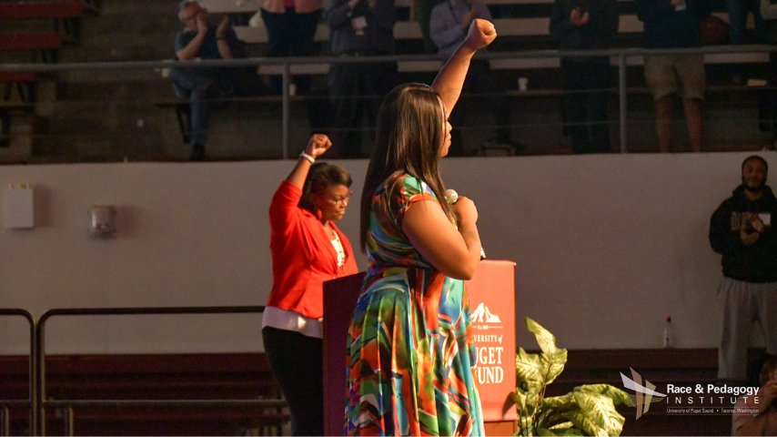 LaToya Brackett raises her first in solidarity with Alicia Garza co-founder of the Black Lives Matter movement during Ms. Garza and Ms. Patric Culler's introduction and welcome to the stage as the final plenary session keynote speakers at the 2018 RPNC. 