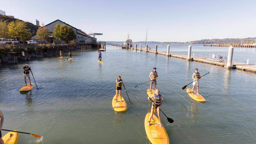 Students on paddleboards on Thea Foss Waterway in Tacoma.