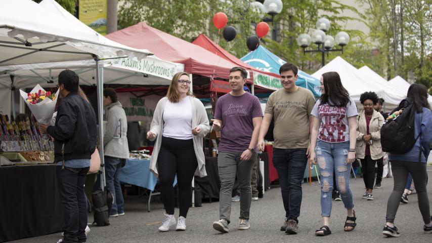 Four students walking through one of Tacoma's farmer's markets