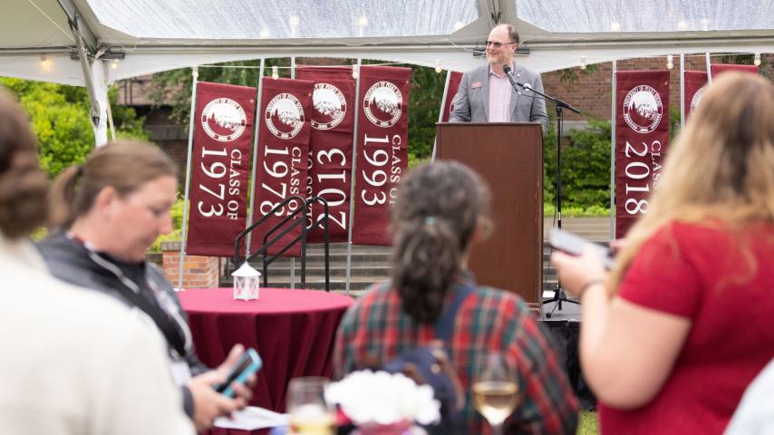 Ted Meriam of the Class of 2005 welcomes guests to Summer Reunion Weekend.