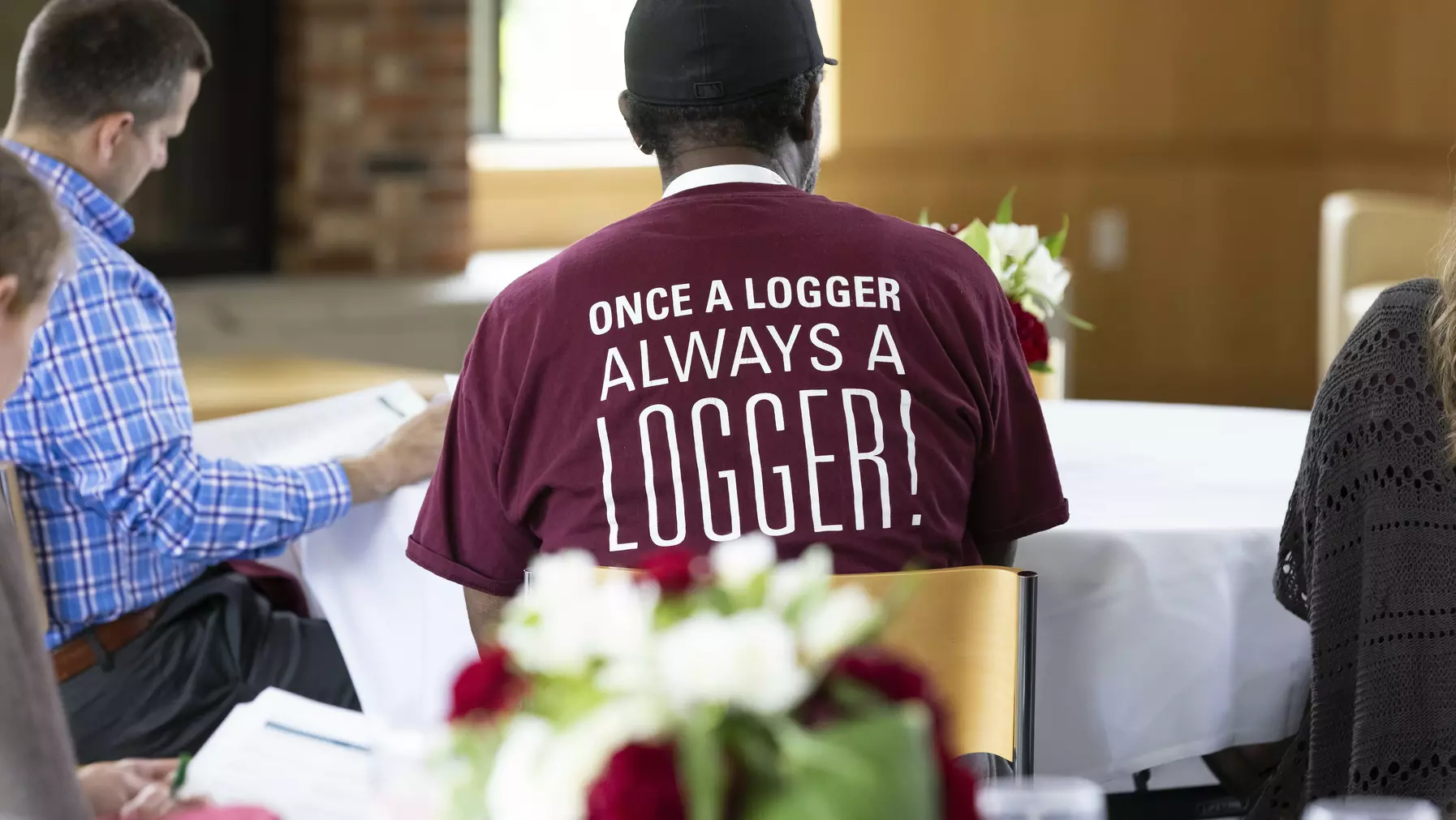 Alumni wearing a T-shirt that reads "once a logger always a logger!"